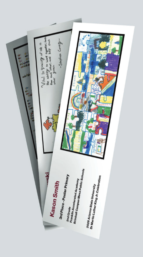 Three white bookmarks showing winning student posters, with the winner's name, place, grade and school