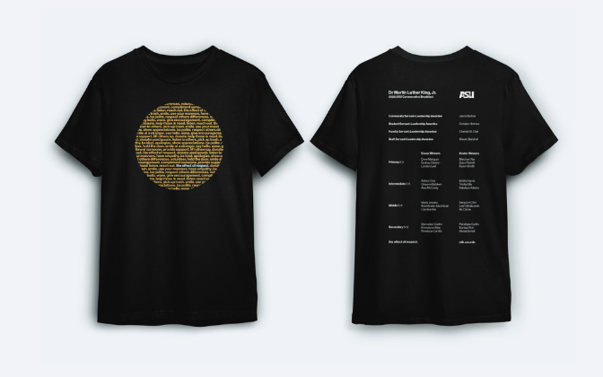 Front and back of a black t-shirt, the front with a gold circle of small text and the back listing the award winners by grade level